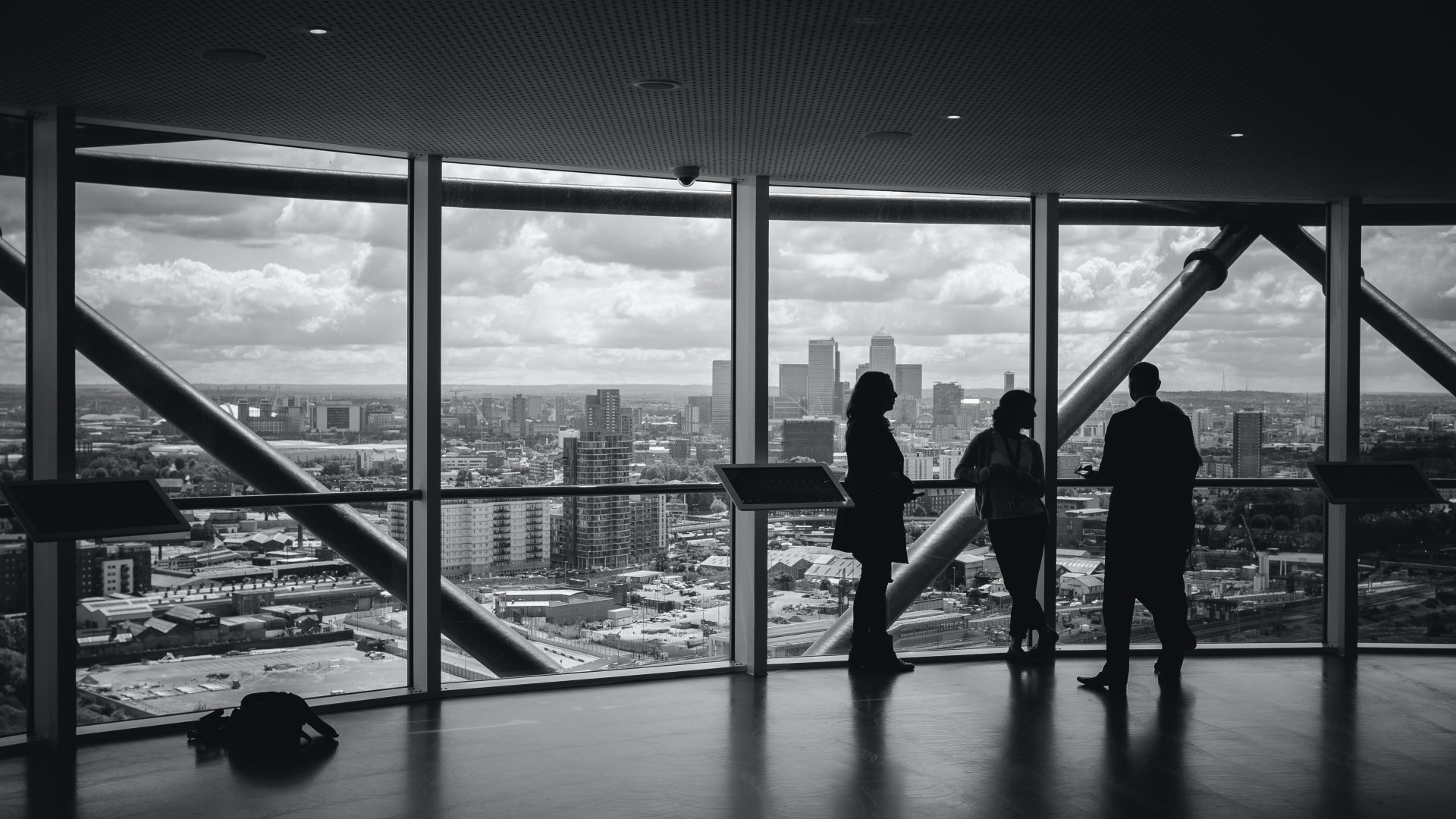 Business people discussing expansion plans beside a city view