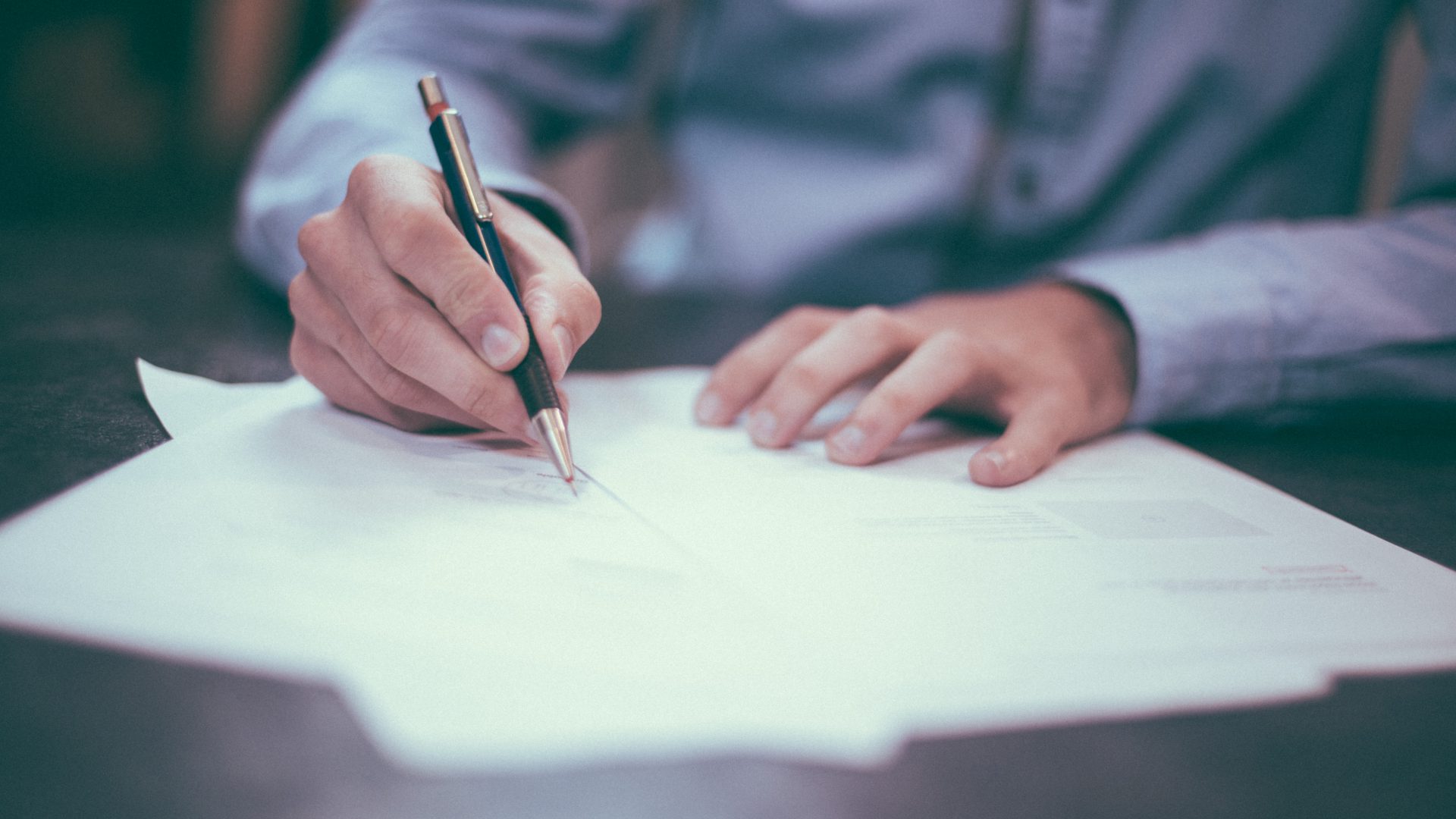 Business finance documents being signed